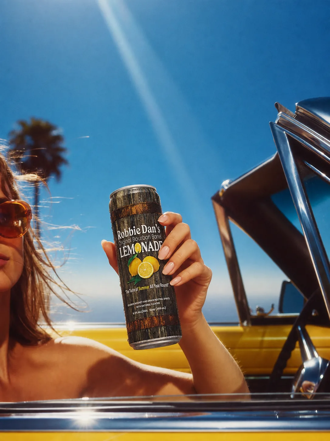 Cans of Robbie Dan’s on the seat of a convertible.